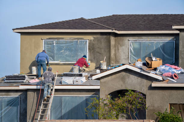 Construction workers plaster the façade of the house as part of General Contracting in Marietta, GA.