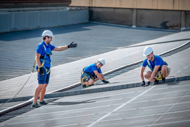 Three workers on a roof, utilizing a ladder for roof repair in Atlanta, ensuring safety and teamwork during maintenance or construction tasks.