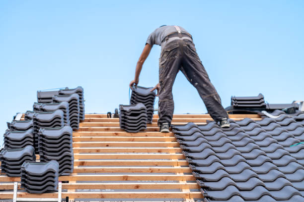 A craftsman installs a fired ceramic tile on the roof while performing waterproofing services in Atlanta.