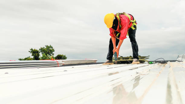  A men repairing a metal roof under a bright sun, representing a metal roof repair company at work.
