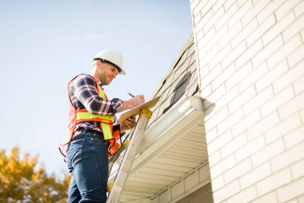 A worker in a hard hat and safety vest is engaged in roof repairs, highlighting roof repairing services.