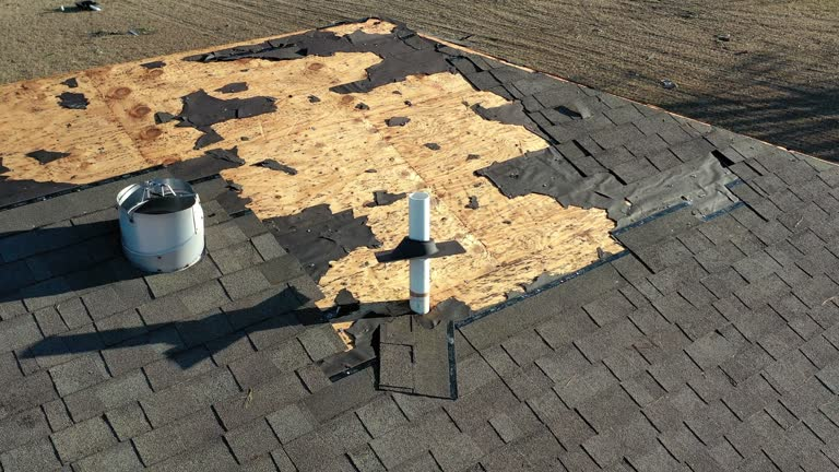  A group of men working together on a flat roof in Atlanta, focused on their tasks and collaborating effectively.