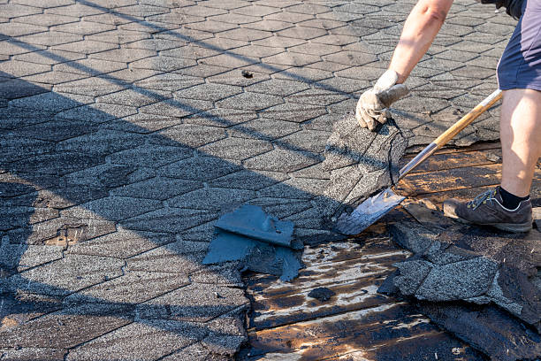  A man engaged in roof repair with a shovel, showcasing the efforts of an affordable roofing company.