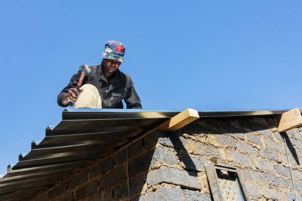 Two workers are applying a metal roof on a flat building in Atlanta, demonstrating teamwork and skill in construction.